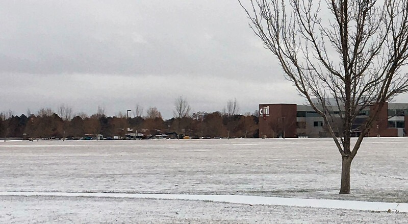 Snow on ground in front of the Nampa Campus Academic Building