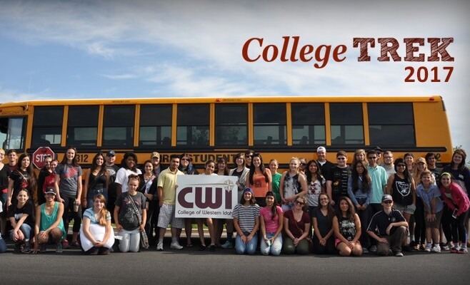 Large group of students holding a CWI sign and standing in front of a bus