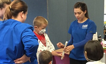 Dental Assisting students demonstration with kids.