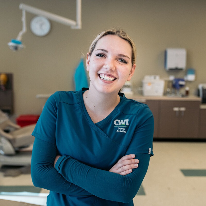 A student of CWIs Dental Assisting program smiles at the camera.