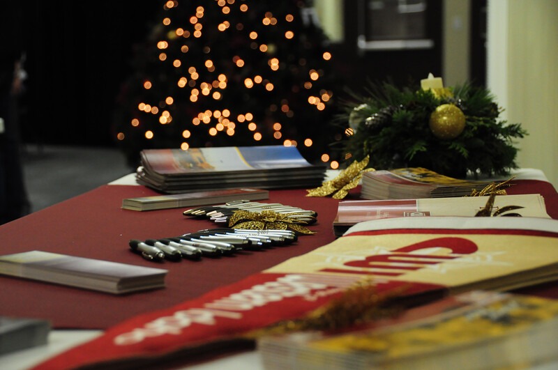 Table with CWI banner, pens, flyers and Christmas in background