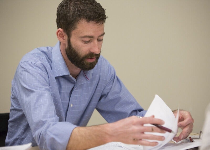 Faculty reviewing papers