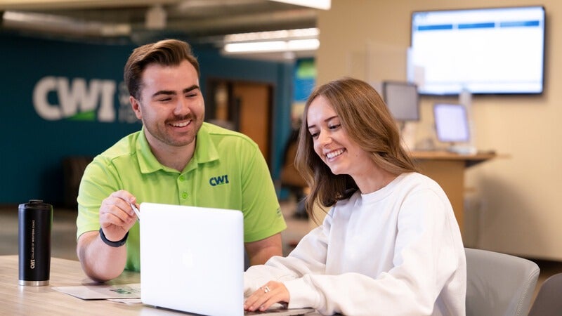 Two people at a laptop