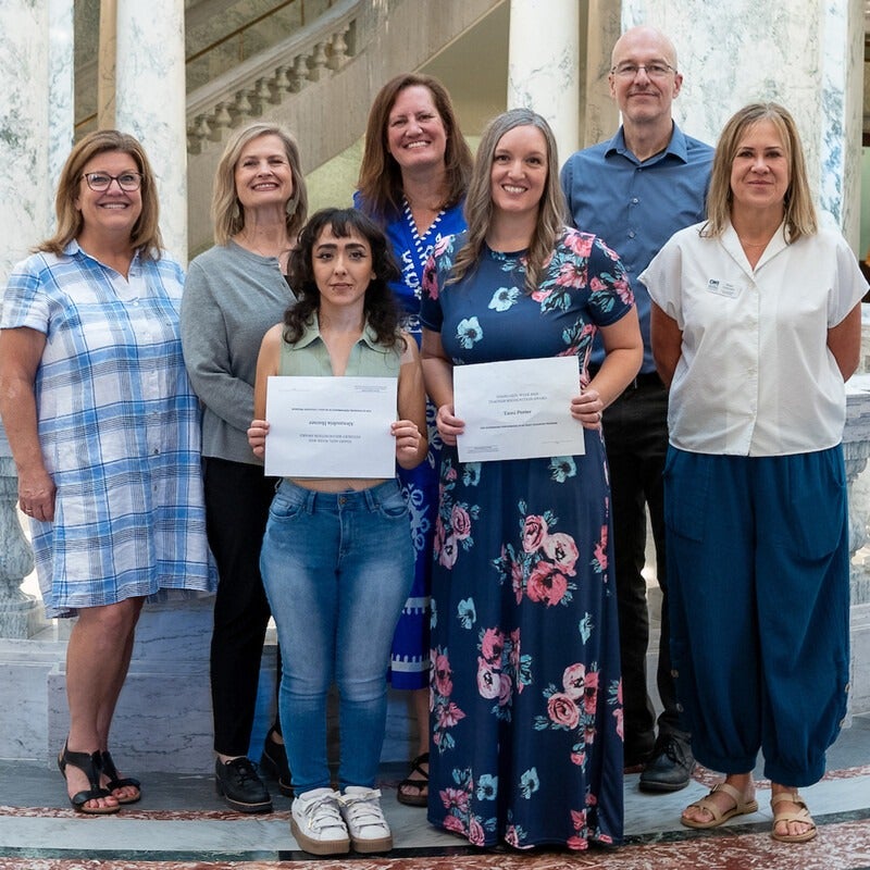 Group of seven people with two award recipients