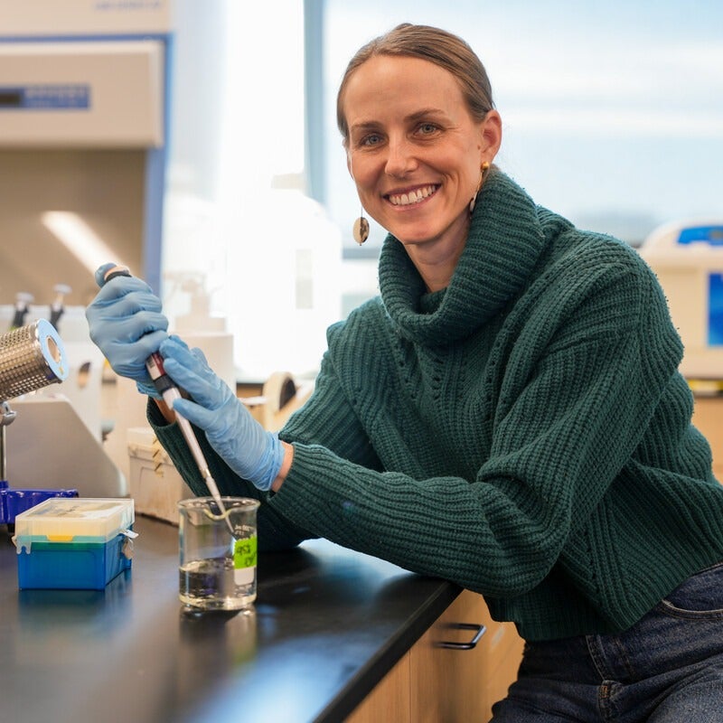 Elise Connor with a pipette at a lab counter