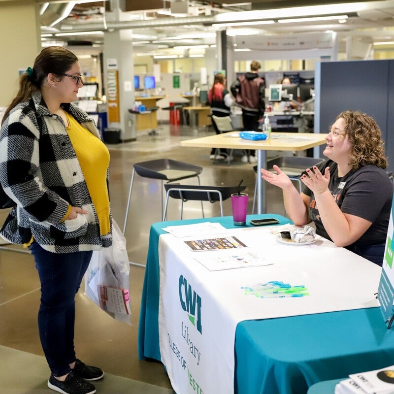 Student talking to librarian