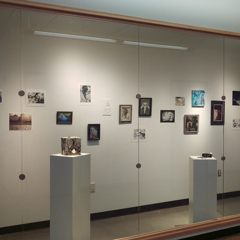 An image of a gallery wall featuring artwork by students from the College of Western Idaho.