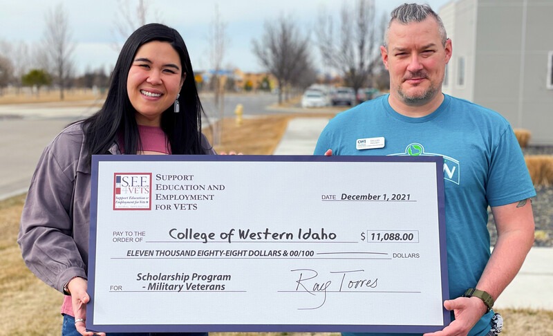 CWI employees, Heather Grayson and Dallas Hulsey, holding check from S.E.E.4VETS