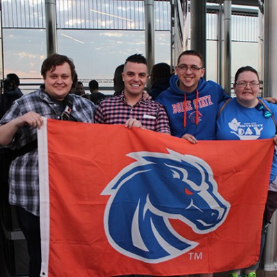 Yeates with fellow Boise State students holding a Boise State flag