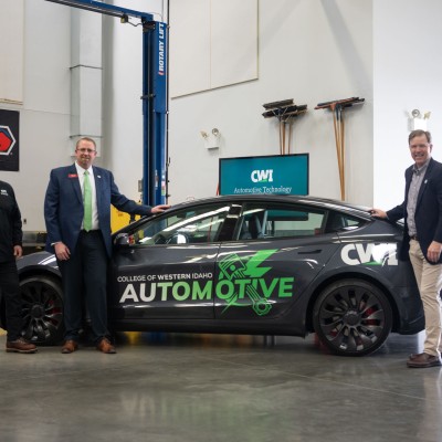 CWI President, Gordon Jones, pose in front of a new Tesla.
