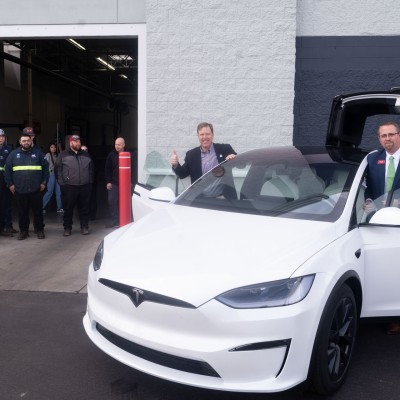 CWI President Gordon Jones gives a thumbs up while inspecting a Tesla at the Micron Education Center.