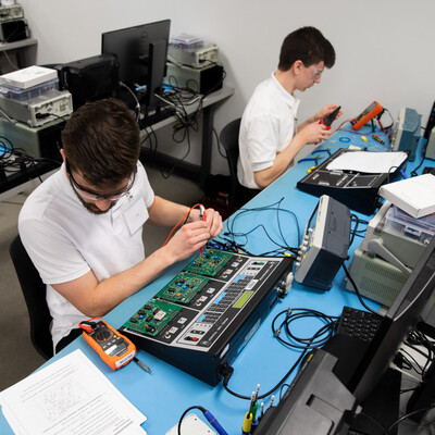 Students work on circuit boards.