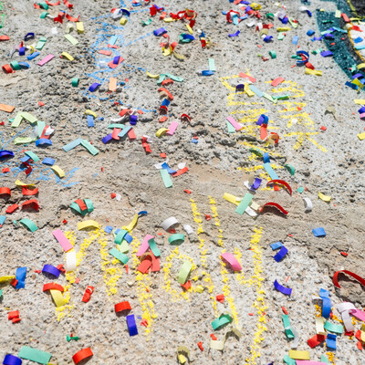 Multicolored confetti is pictured covering the cement of newly constructed bridge on the campus of CWI.