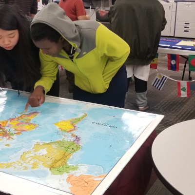 Students looking at a map during the International Club's Cultural Meet and Greet