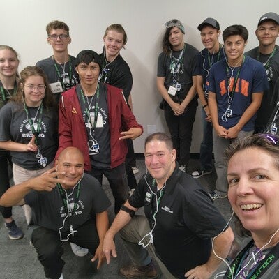 Group of people posing for a photo and looking at the camera