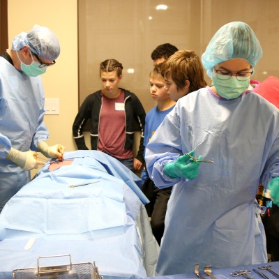 Eric Strayer, Surgical Technology Instructor, demonstrates a procedure during STEM Out!