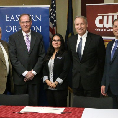 College of Western Idaho President, Bert Glandon, from left, CWI Dean of Extended Instruction, James Jansen, and Eastern Oregon University's Priscilla Valero, Ontario Regional Center Director, David Vande Pol, Executive Director of Regional Outreach and Innovation and President, Tom Insko, pose for a photo after a ceremony to sign an articulation agreement between the two schools on Monday, Nov. 6. 2017, in Nampa, Idaho.
