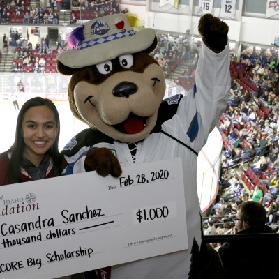 Casandra Sanchez, SCORE Big Scholarship recipient, with Idaho Steelheads mascot, Blue.