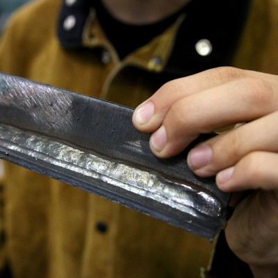 Student holding piece of metal