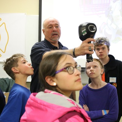 Kevin Platts, Director of Public Safety Programs, illustrates how a FLIR thermal camera works during STEM Out!
