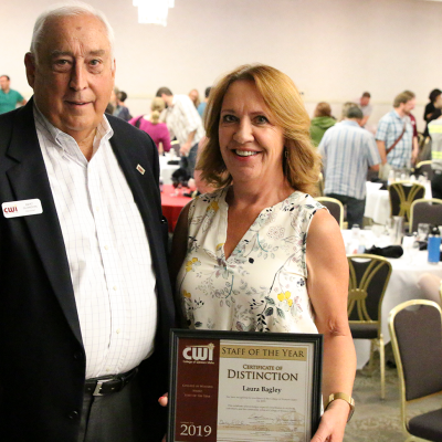 President Bert Glandon congratulates Laura Bagley, College of Western Idaho’s Staff of the Year for 2019, following the Fall Add