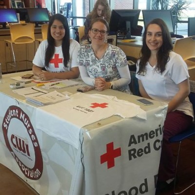 Members of SNA sitting at a table at the Nampa Campus Academic Building for a blood drive