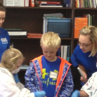 Dental Assisting Program students demonstrating oral health with elementary students.