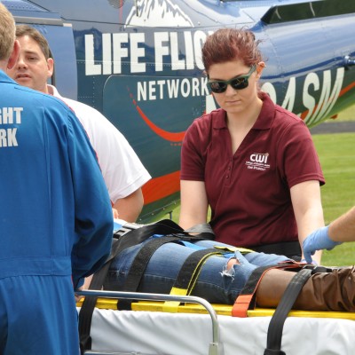 Advanced EMT students helping transport patient to Life Flight helicopter.