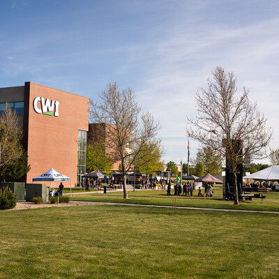 A photo of CWI campus with event tents, a climbing wall, a mechanical bull, and more for the 2024 Grad Fest.