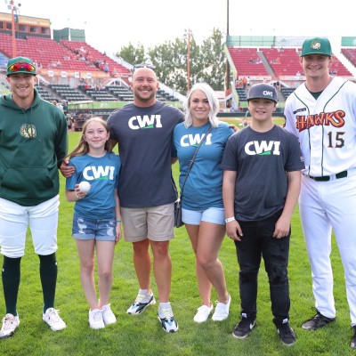 Craig Petersen and family posing with Boise Hawks players