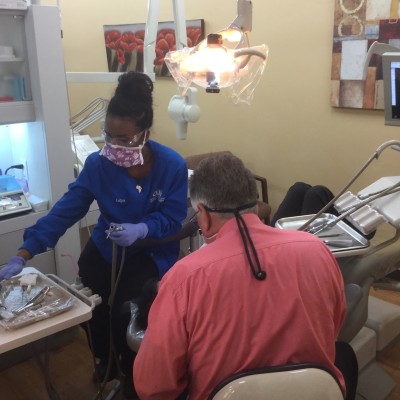 Dental Students working on a patient with dentist