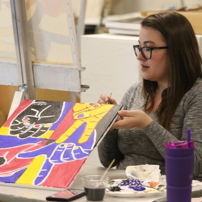 Student painting during paint workshop Feb. 20.