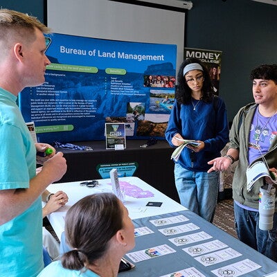 Students chat with man at job fair
