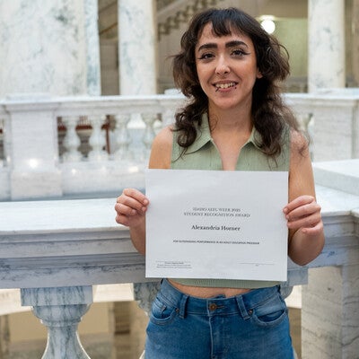 Student award recipient holding certificate