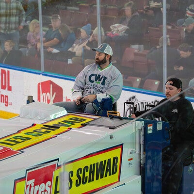 Person in CWI gear rides Zamboni 