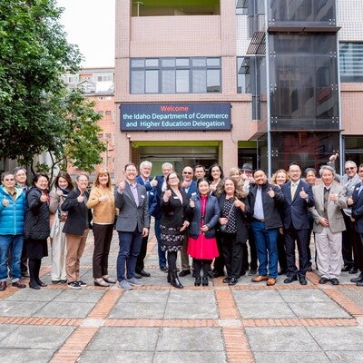Group picture in front of a sign that states the Idaho Department of Commerce and Higher Education Delegation