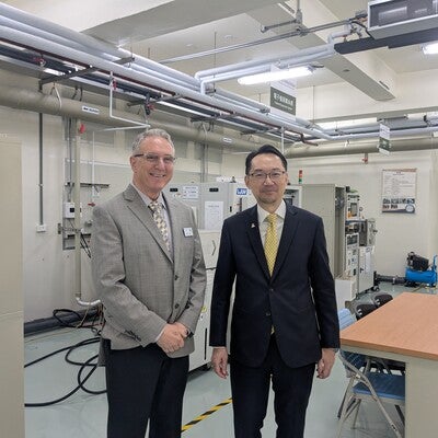 Two people standing in the middle of a lab