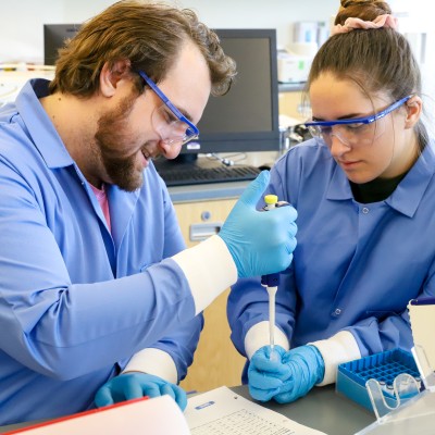 INBRE scholars working together with Biology equipment