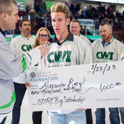 Alexander Lacy accepting a scholarship check