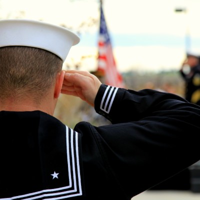 Navy Veteran saluting american flag