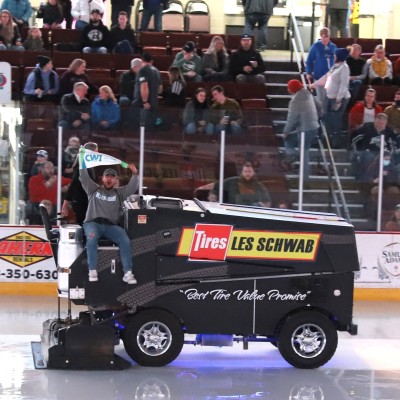 Enrollment Counselor, Jared Lopez, riding on the Zamboni