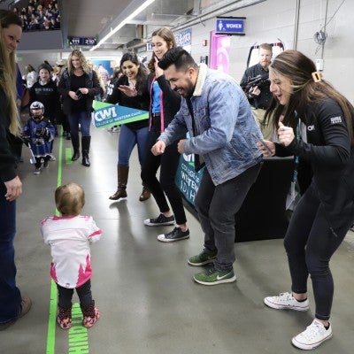 CWI Enrollment Team dancing with a fan