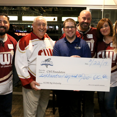 Steelheads Senior Account Executive, Steven Anderson, presenting a check to the CWI Foundation