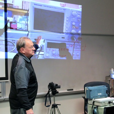 Mike Scuka shows how the prototype for his overhead electronics display works.