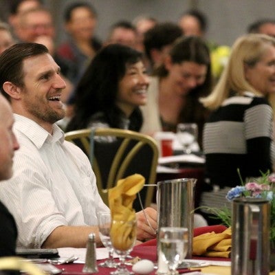 Employees at tables at the Staff Celebration Breakfast and Meeting