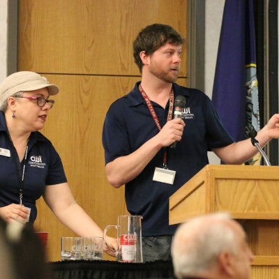 Juddson Constantine and Juanita Martinez at podium during the Staff Celebration Breakfast and Meeting