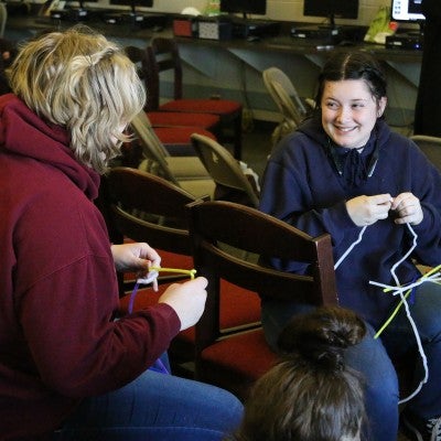 Students working with pipe cleaner for a project during CWI Day at Frank Church High School