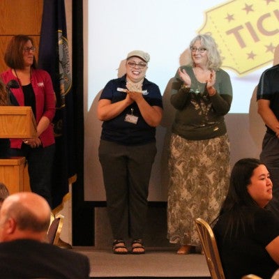 Employees giving presentation at the Staff Celebration Breakfast and Meeting