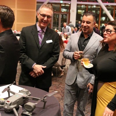 Robert Novak, Engineering Department Chair, talks with visitors during the Opening Doors Benefit Event.