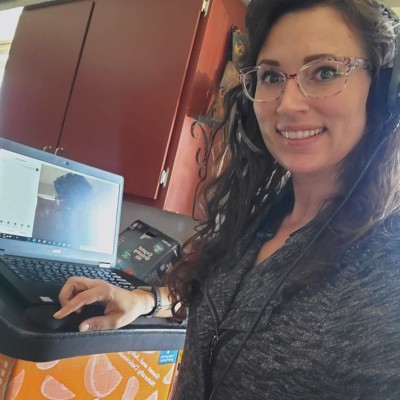 Amy Vassar working from home with a makeshift stand-up desk for her laptop